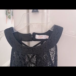 a black lace dress, fits small but not tight